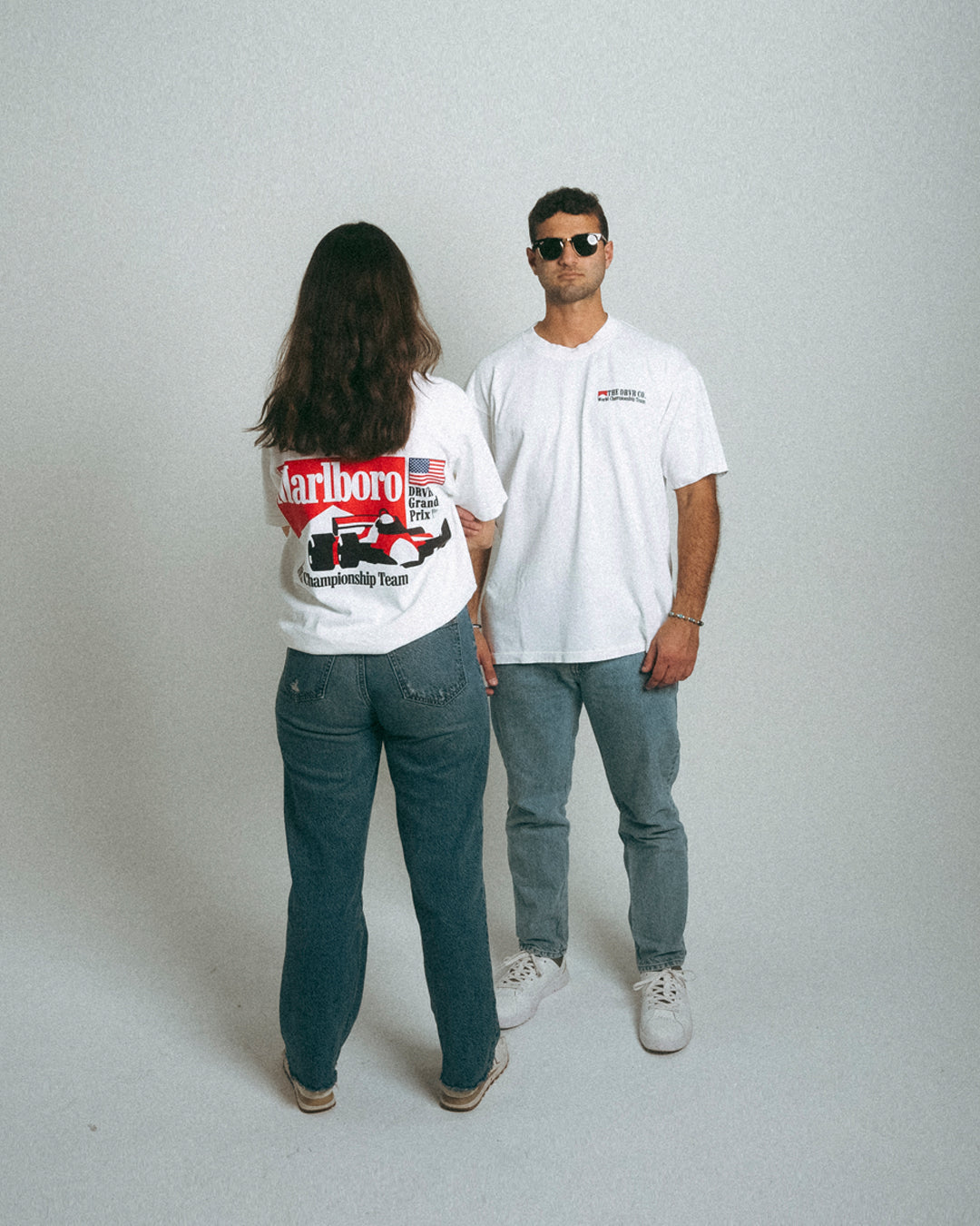 Man and woman sporting White heavyweight racing shirt, looking from the front and from the back