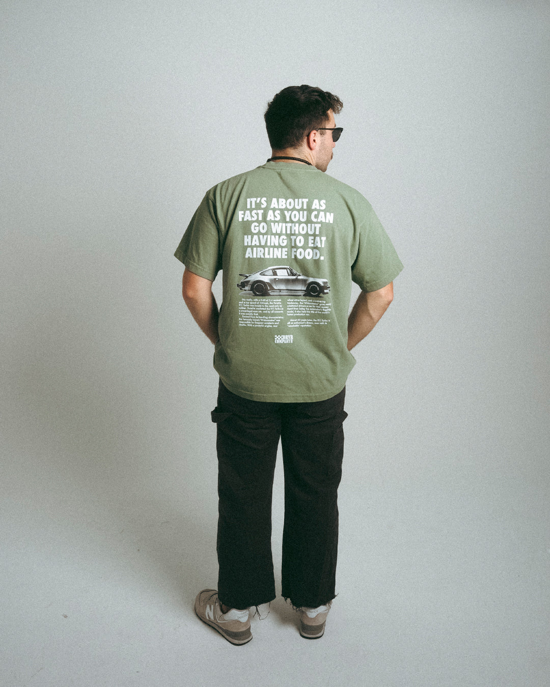 Man leaning over wearing green tee shirt