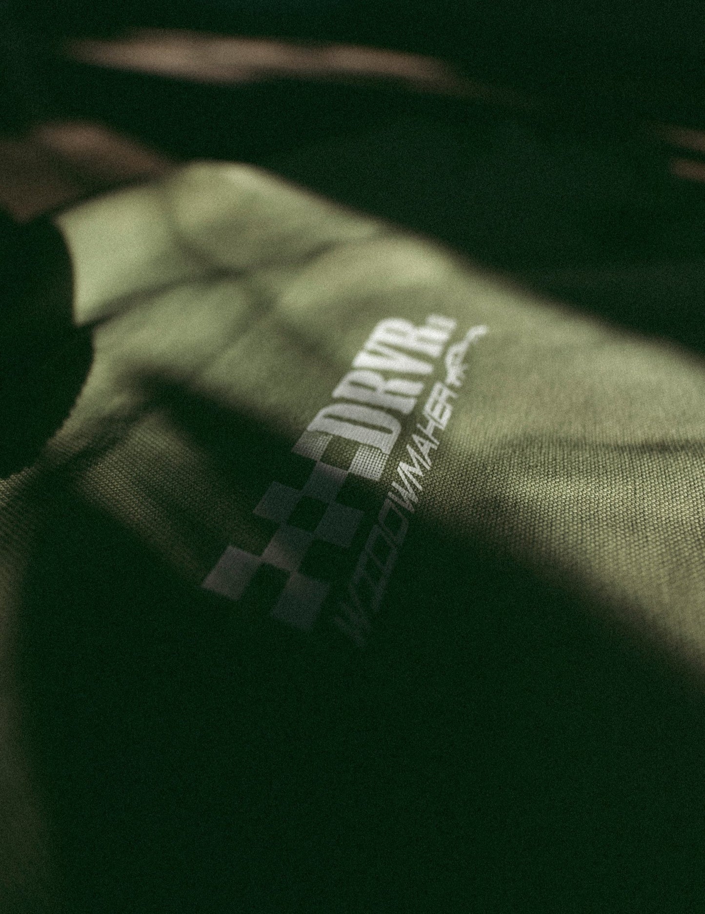 green shirt on floor focused on front racing logo