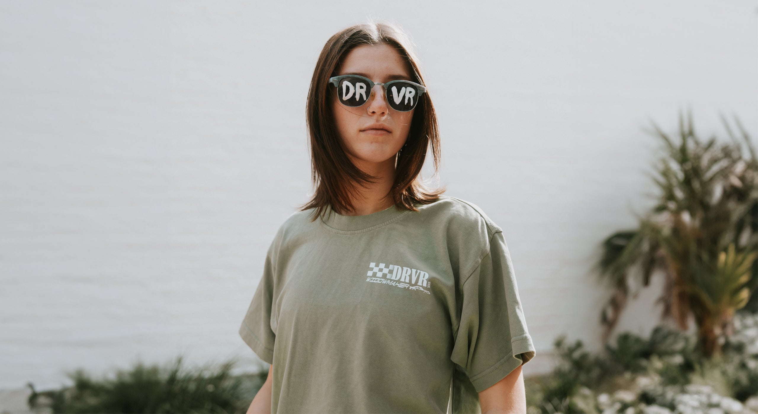 Girl wearing Green Widowmaker shirt in park