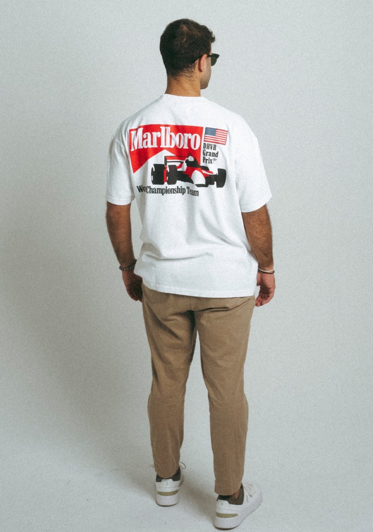 Man wearing white and red heavyweight Marlboro racing shirt