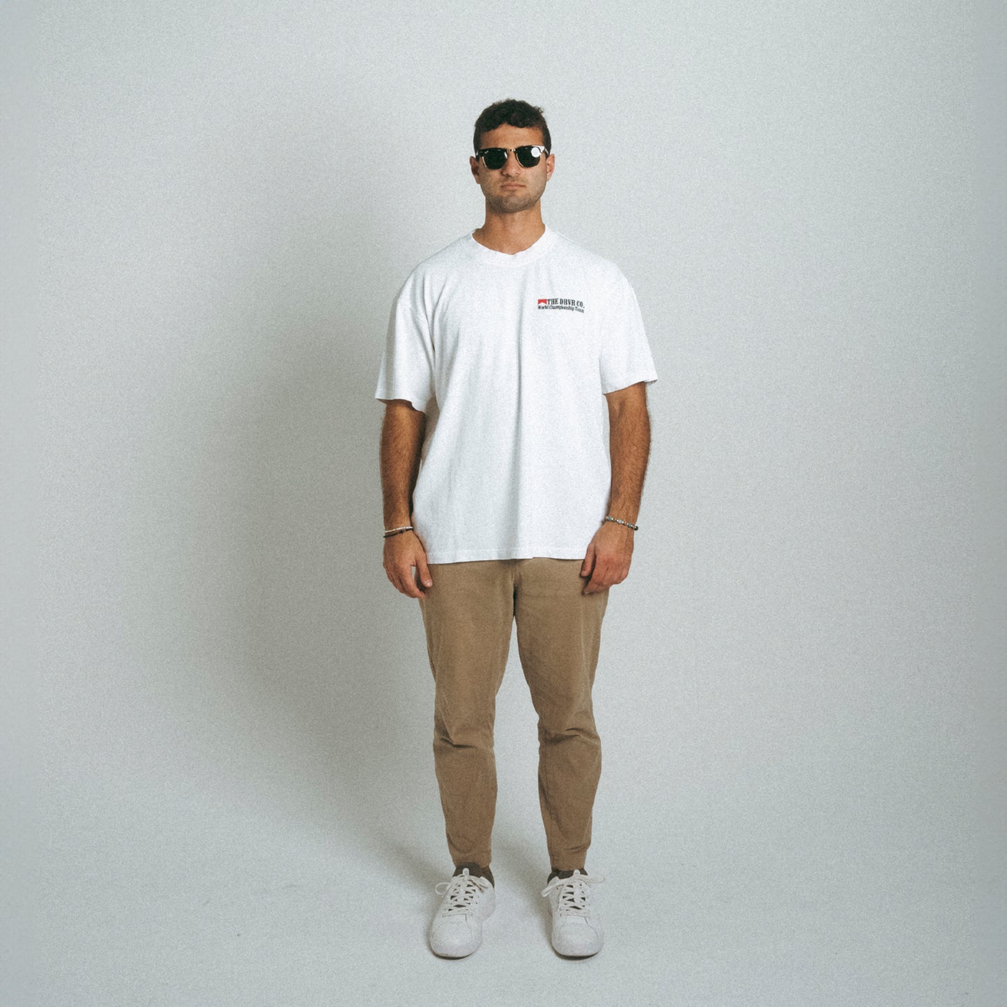 Man looking head on wearing white oversized heavyweight shirt
