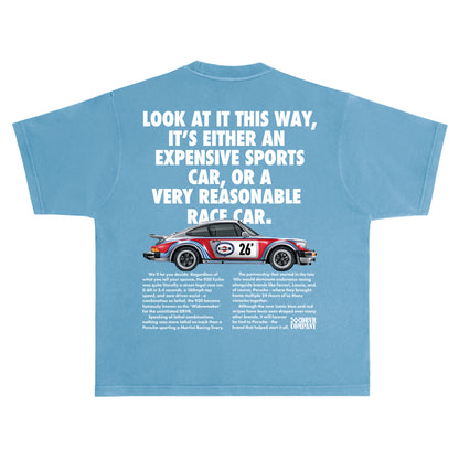Blue t-shirt with a graphic of a race car and humorous text on a white background