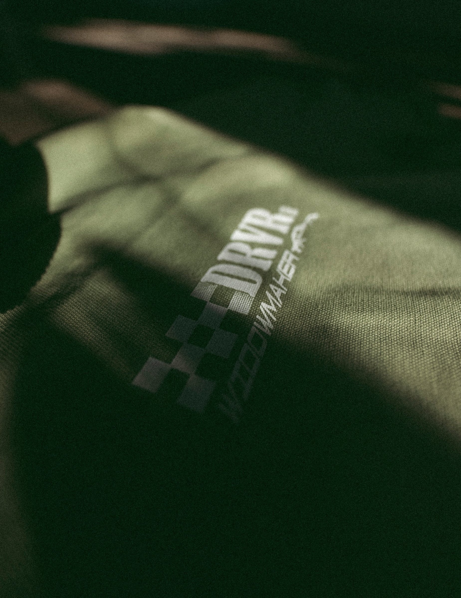 green shirt on floor focused on front racing logo