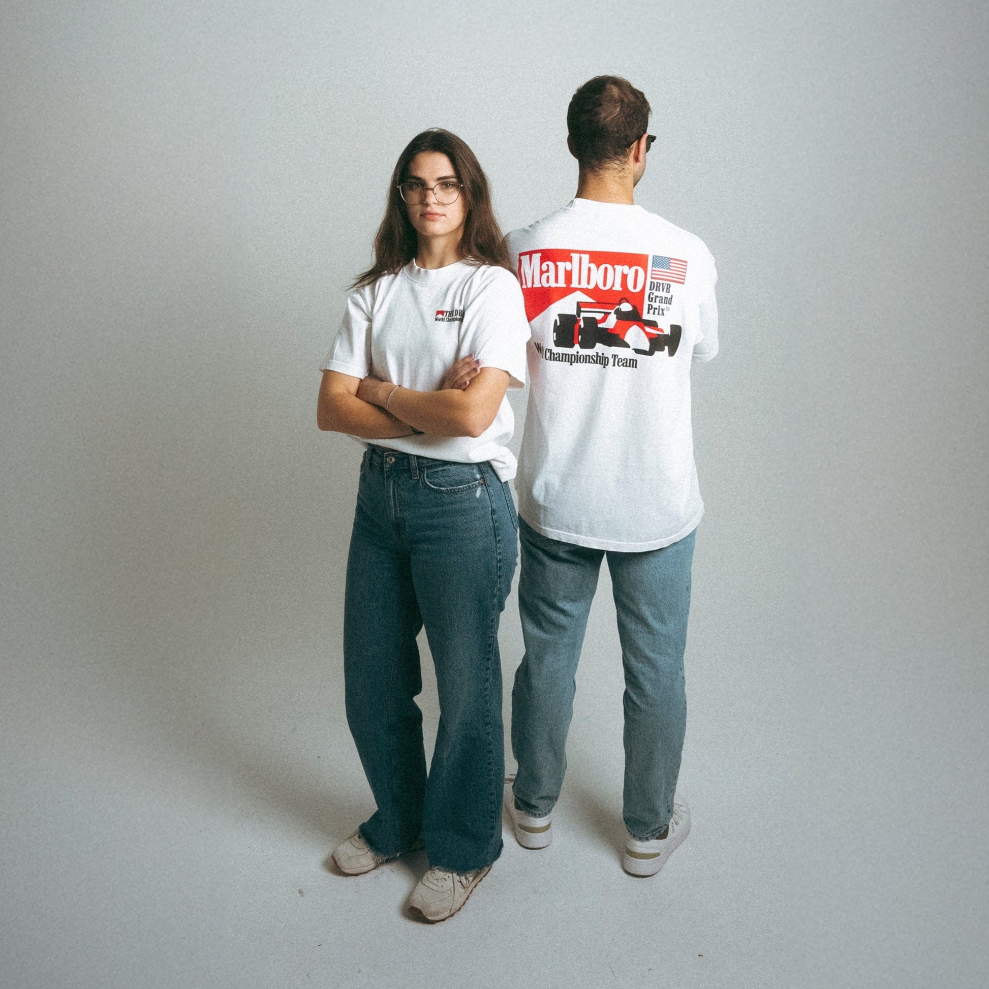 man and woman in studio wearing racing shirts