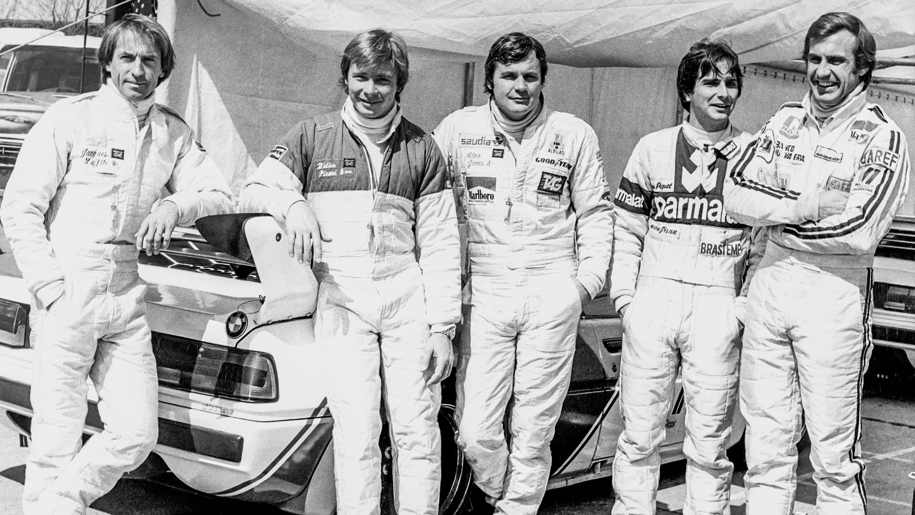 rally drivers posing in front of bmw