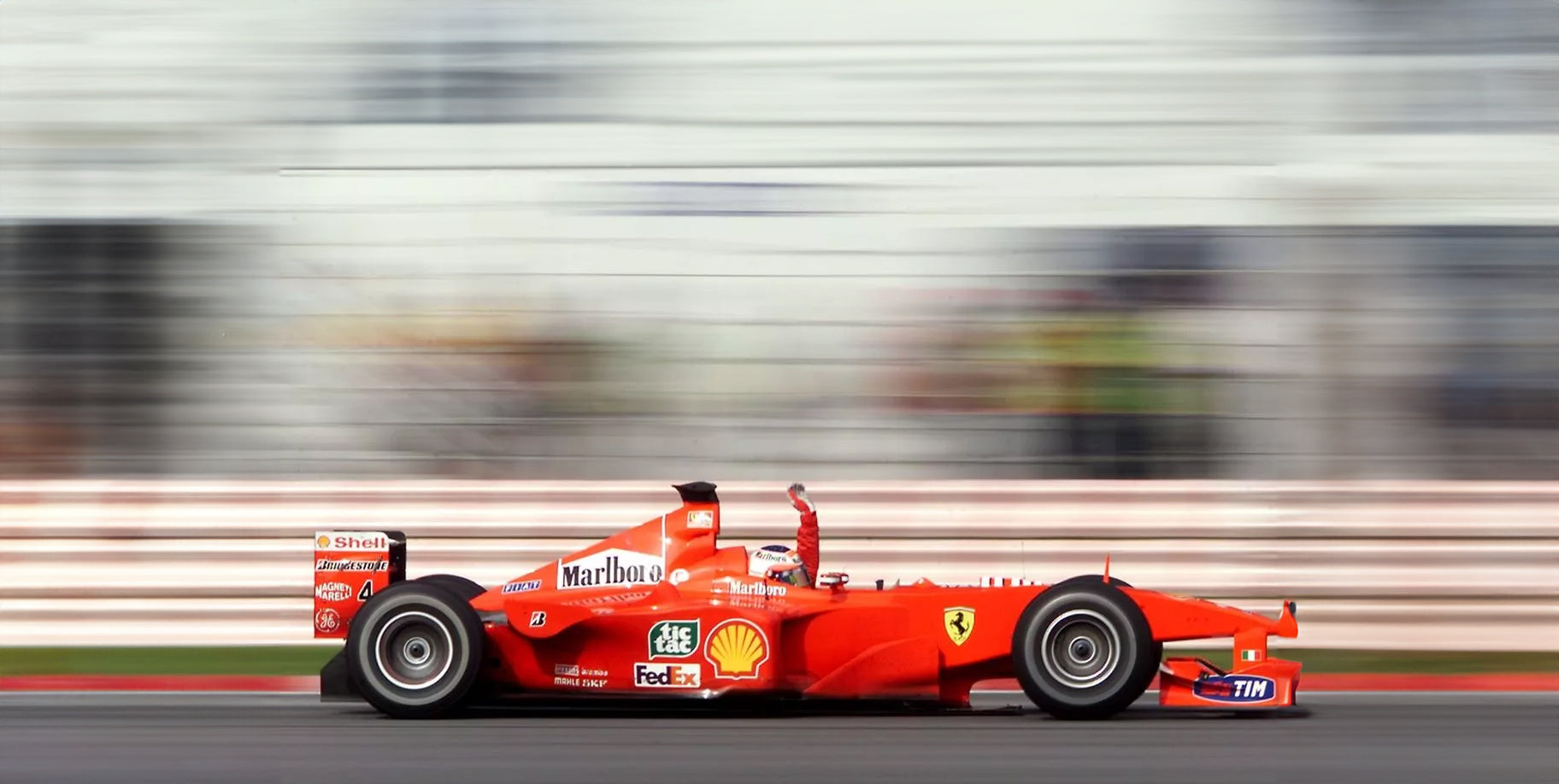 Rolling shot of Michael Schumacher racing for Ferrari in Marlboro livery